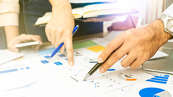 group of hands reviewing documents