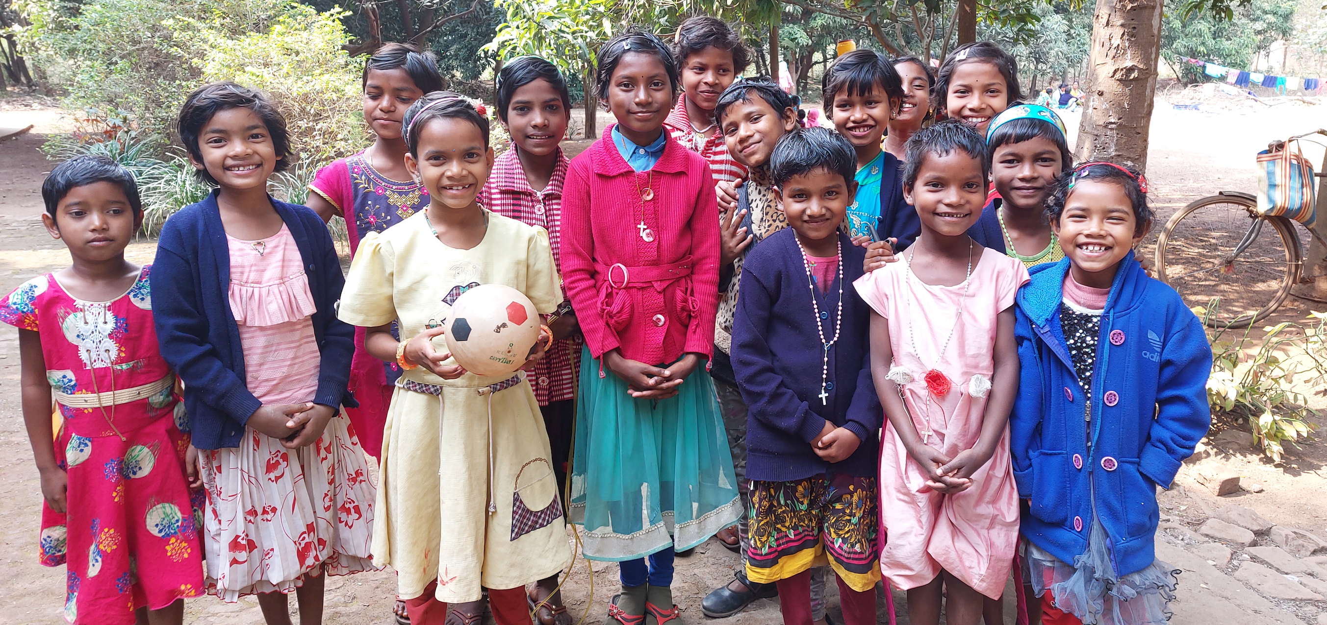 Group of kids posing after a game of soccer in Boropahari