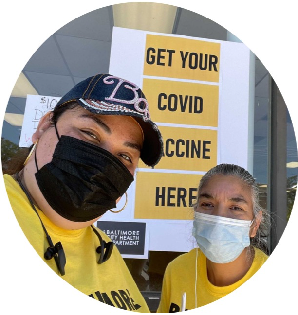 VALUE volunteers in front of sign