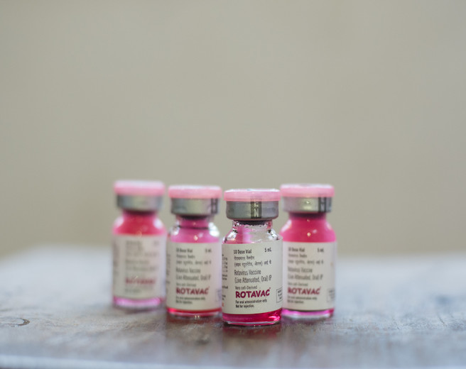 Four unopened Rotavac vaccine vials lined up next to each other