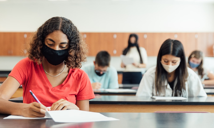 College students in masks studying