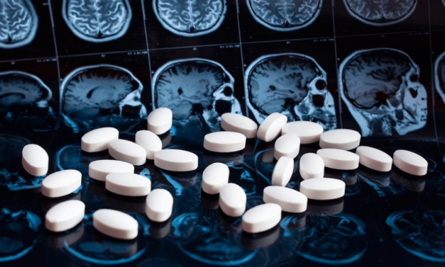 A composite image of pills overlaid on MRI imagery