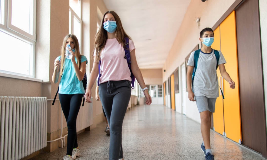 Kids walking in hallway with masks on