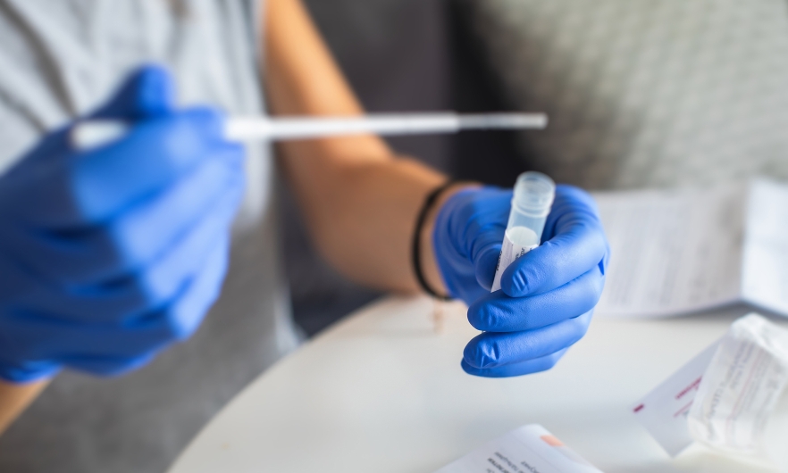 Person holding a COVID-19 Test Tube