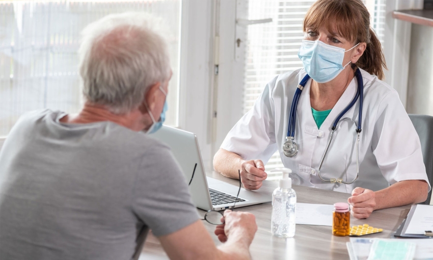 Elderly man consulting with a doctor 