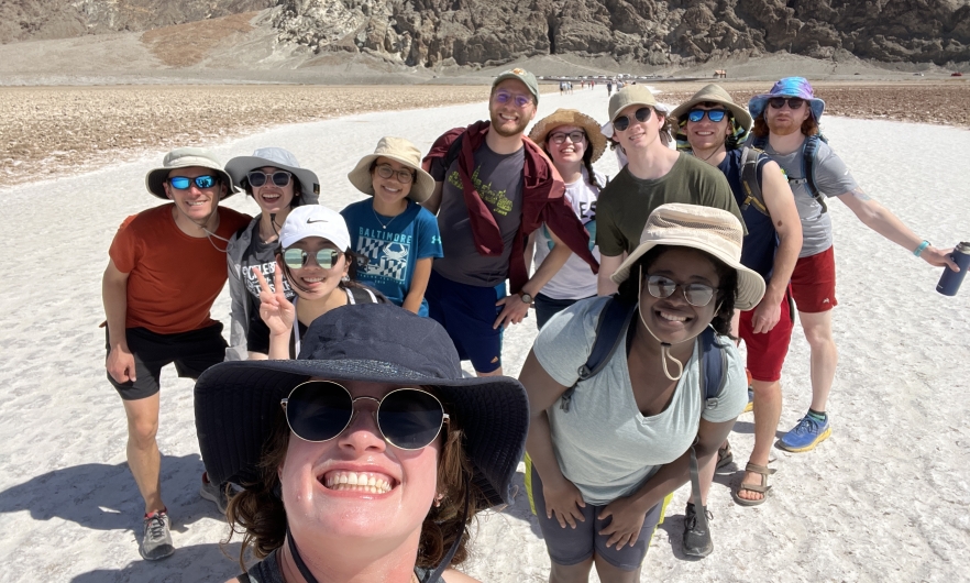 group of students in a group photo in a desert setting