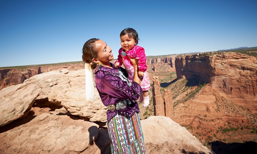 Photograph of woman and child in American Indian clothing.