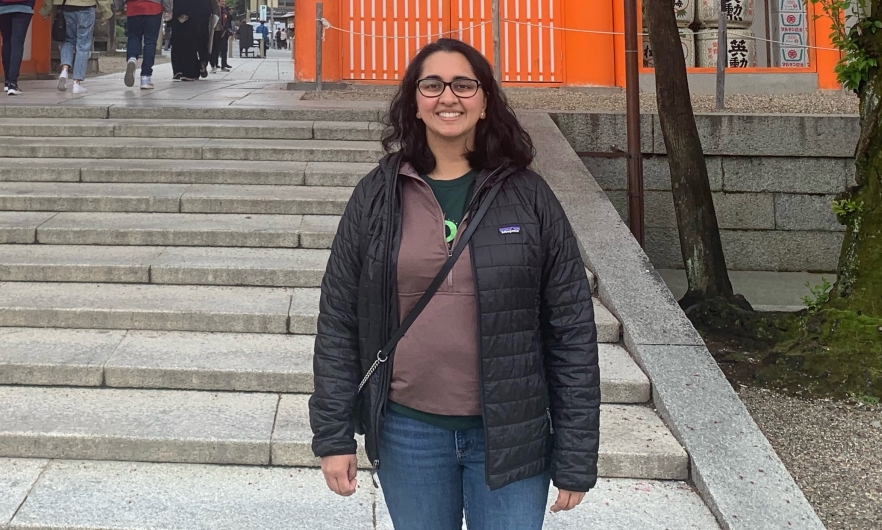 woman stands in front of steps