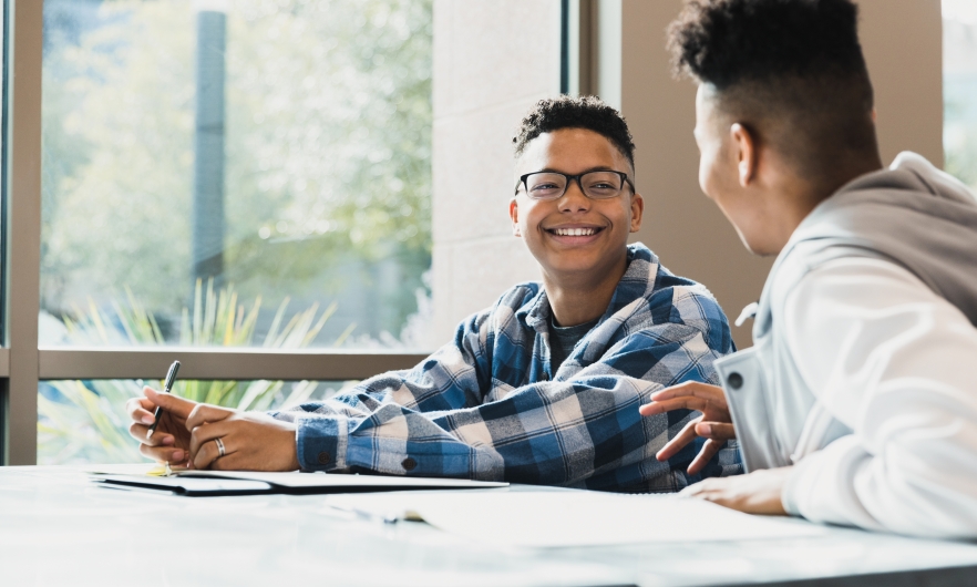 Two young boys at a desk 