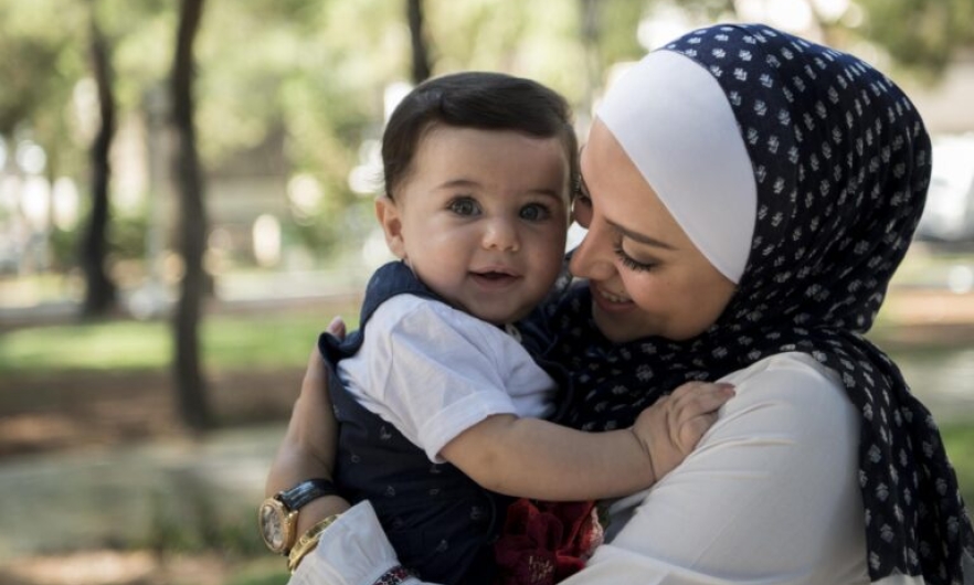 Mother affectionately holding her baby.