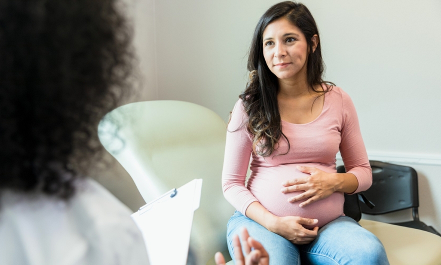 Photo of pregnant woman with doctor.