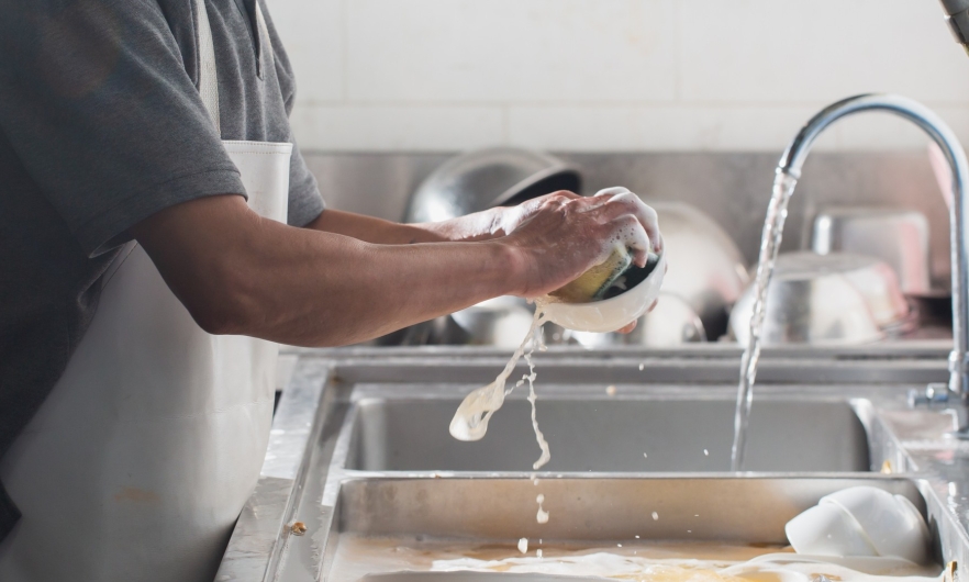 photo of person washing dishes 