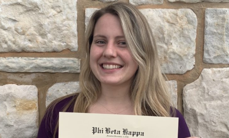 Young woman smiling holding a certificate 