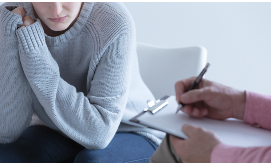 photo of woman talking to someone with clipboard