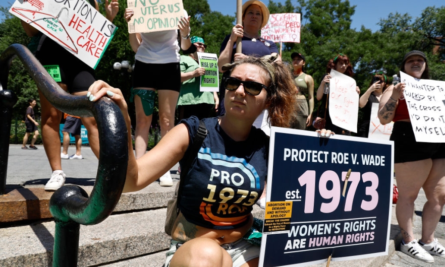 People hold up signs in Union Square during a demonstration against the Supreme Court on July 4, 2022 in New York City. The Supreme Court's June 24th decision in the Dobbs v Jackson Women's Health case overturned the landmark 50-year-old Roe v Wade case, removing a federal right to an abortion. 