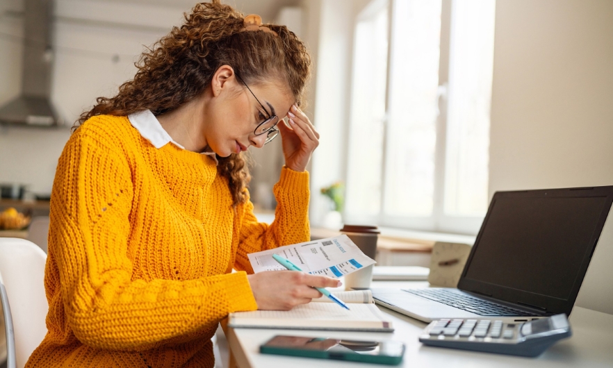 Woman at desk looking frustrated.