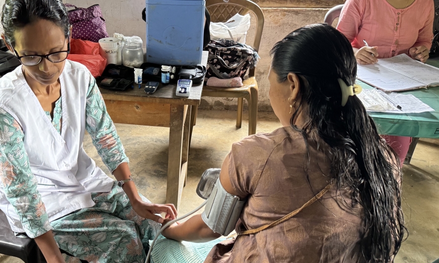 Taking blood pressure in West Garo Hills, Meghalaya state, India