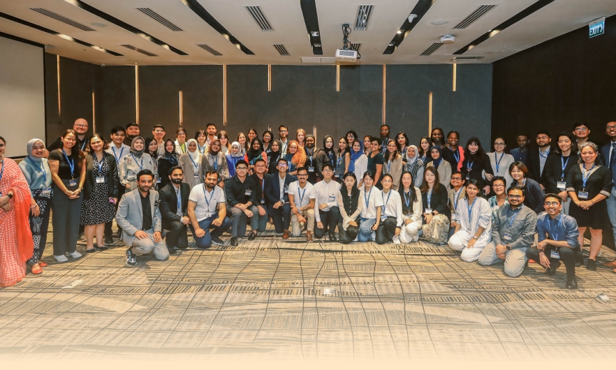 A large group of participants ages 19–35 gather for a group photo during the Ascend 2024 in-person workshop