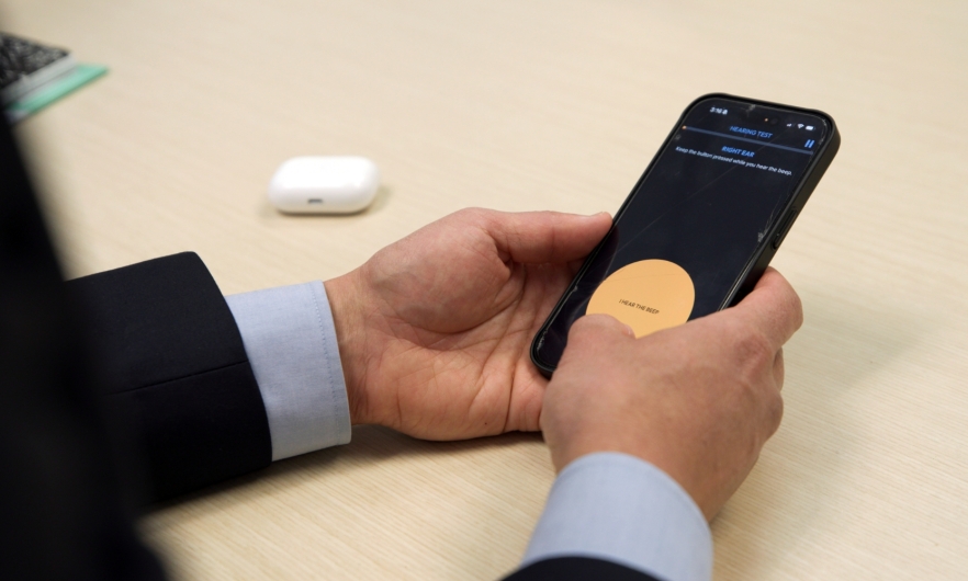 A person takes a hearing test on their smartphone