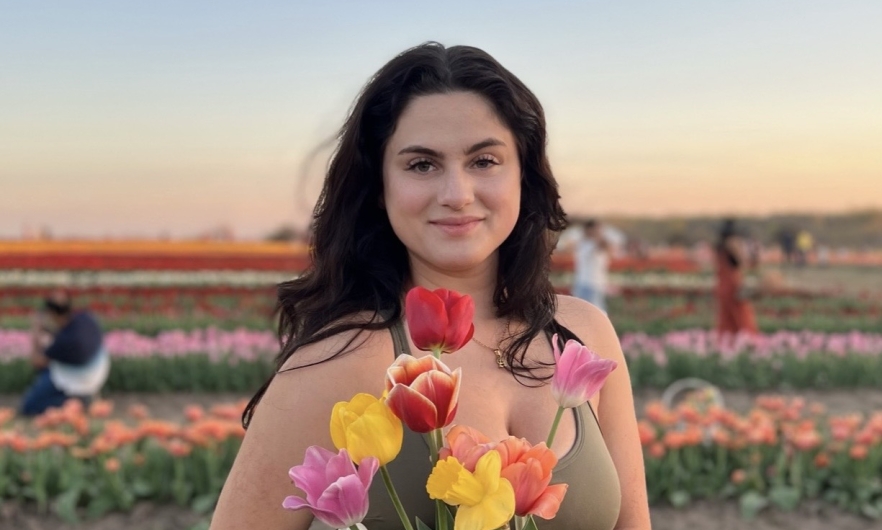 Young woman standing in field of flowers