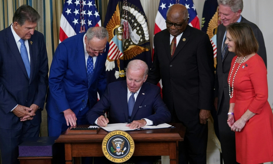 President Joe Biden signs the Inflation Reduction Act of 2022 into law during a ceremony in the State Dining Room of the White House in Washington, DC, on August 16, 2022.