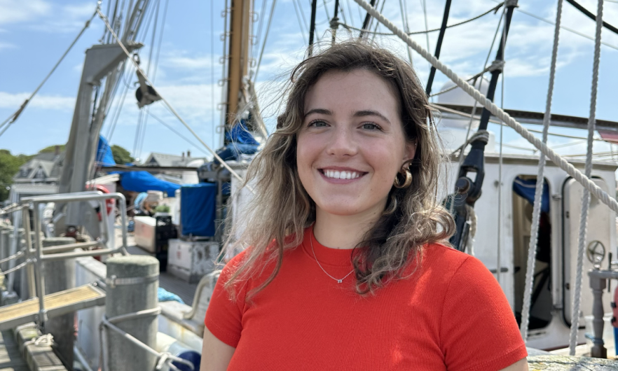 Young woman wearing red t-shirt standing on a large boat