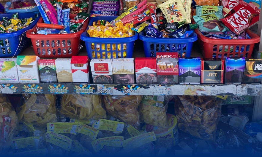 Colorful display of cigarettes near candy at children's eye level at a point of sale in Ecuador