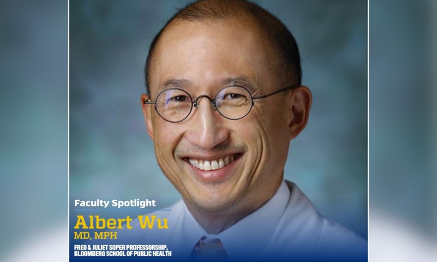 A headshot of a man wearing a white collared shirt.