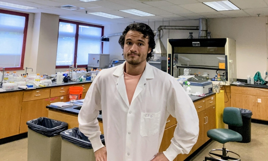 Male in a white lab coat in a lab