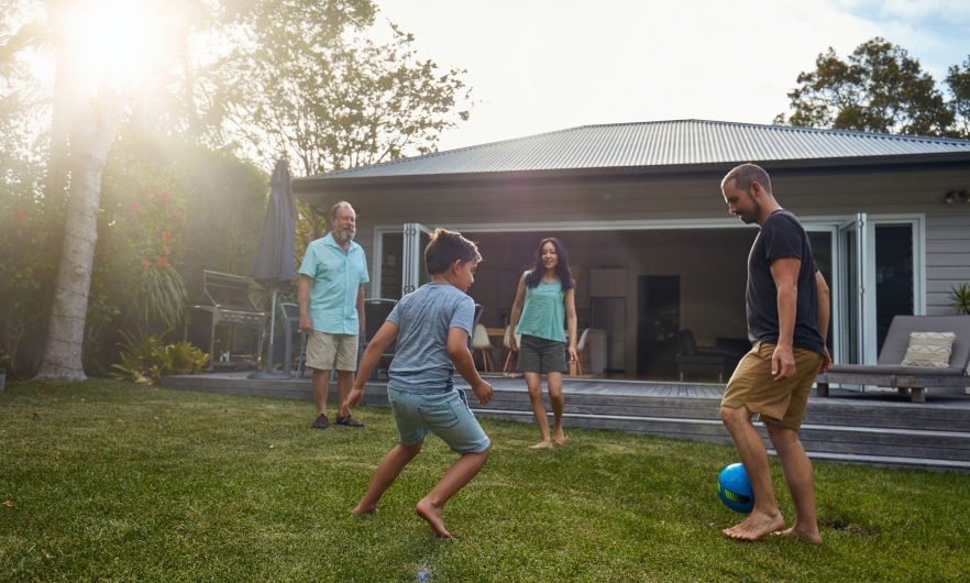 Family playing soccer outdoors