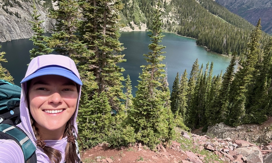 Selfie of a young woman in front of a lake