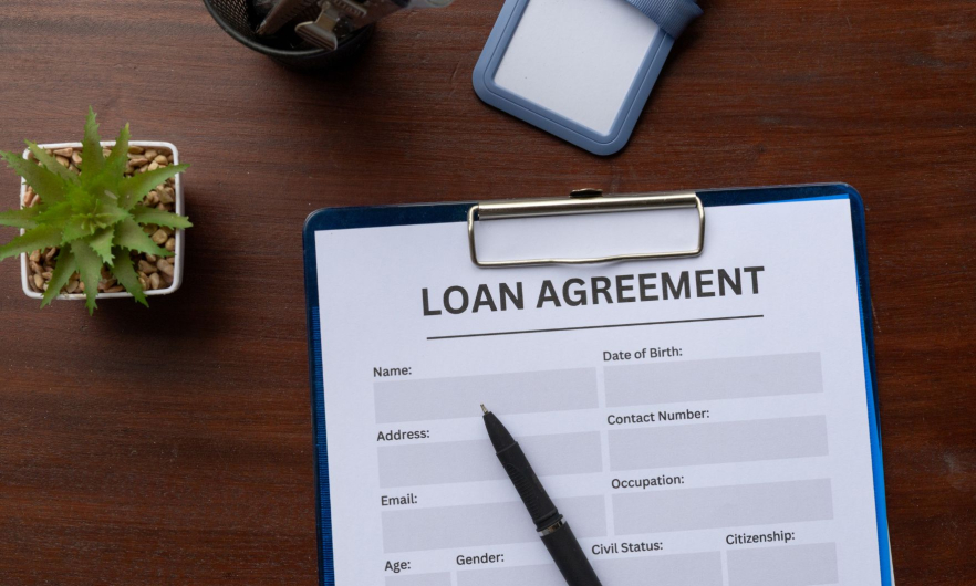 A an empty paper form titled Loan Agreement clipped to a clipboard.