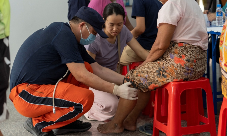 A member of China Search and Rescue Team provides medical consultations for local residents in Mandalay,  Burma (Myanmar),