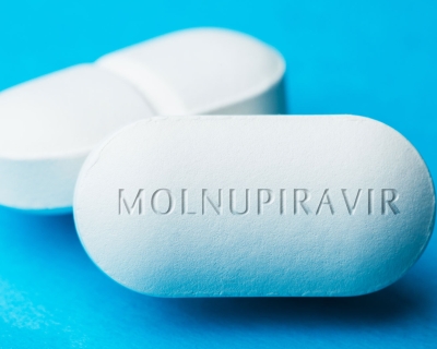 white pills with the word "molnupiravir" written