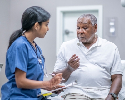 Elderly man consulting with a doctor 