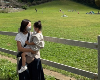 mother holding her child both wearing masks