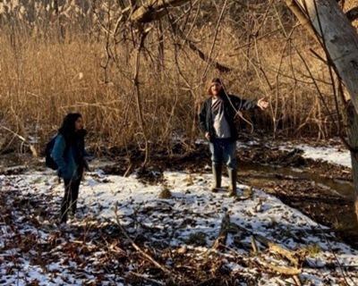 students discussing project in a snowy patch of ground