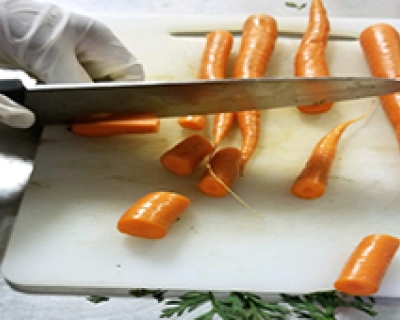 A student slicing carrots