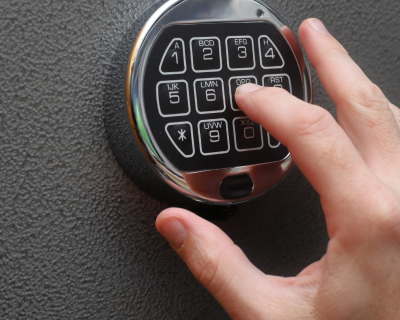 A person inputting a code on a safe lock