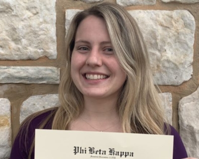 Young woman smiling holding a certificate 