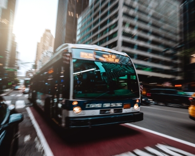 Bus approaching in bus lane on busy city street