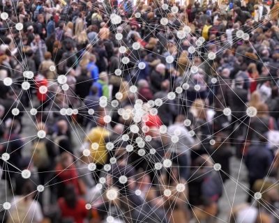 Conceptual image of disease particles connecting over a large crowd of people.