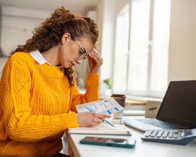 Woman at desk looking frustrated.