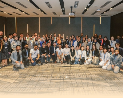 A large group of participants ages 19–35 gather for a group photo during the Ascend 2024 in-person workshop