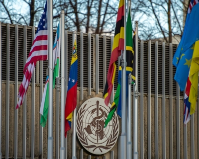 Outside the W.H.O.'s Geneva headquarters, flag poles flying flags of member states, including the U.S.