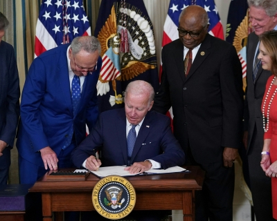 President Joe Biden signs the Inflation Reduction Act of 2022 into law during a ceremony in the State Dining Room of the White House in Washington, DC, on August 16, 2022.