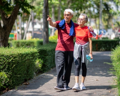 photo of older couple walking in park