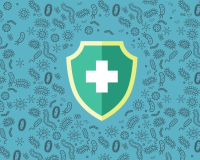 Green shield with white medical cross in the center of a teal background illustrated with hundreds of microbes