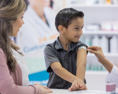 Child smiling after receiving a vaccination