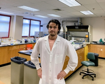 Male in a white lab coat in a lab